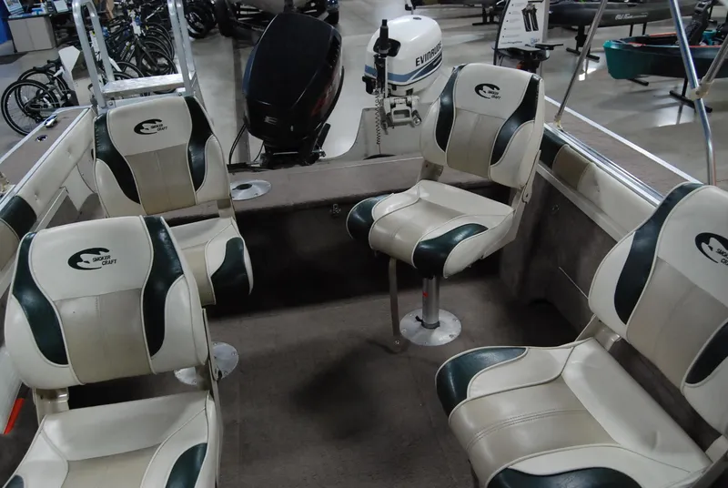 Slide: The Image of 1998 Smoker Craft 178 Fazer boat interior with four seats and dual outboard motors. - 21
