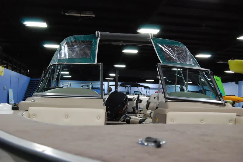 Slide: The Image of 1998 Smoker Craft 178 Fazer boat interior with windshield and canopy in showroom. - 22