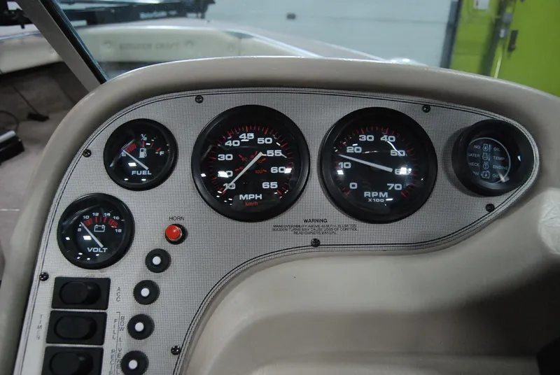 Slide: The Image of Dashboard of a 1998 Smoker Craft 178 Fazer boat with gauges and controls. - 23