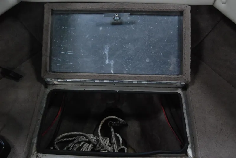 Slide: The Image of Open storage compartment with rope in 1998 Smoker Craft 178 Fazer boat. - 29