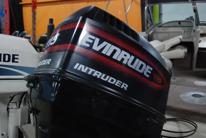 Slide: The Image of 1998 Smoker Craft 178 Fazer with Evinrude Intruder 115 outboard motor in a garage setting. - 35