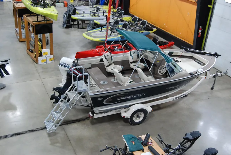 Slide: The Image of 1998 Smoker Craft 178 Fazer boat in showroom with trailer and canopy. - 5