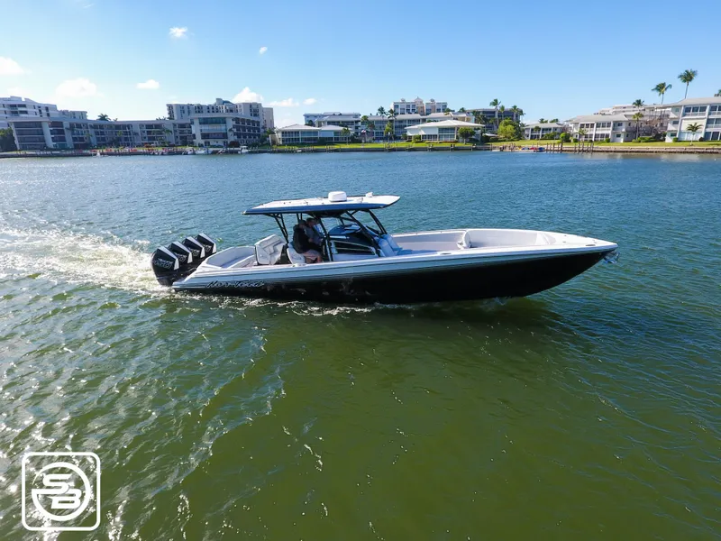 Slide: The Image of 2021 Nor-Tech 390 Sport boat cruising on a sunny day in a waterfront area. - 11