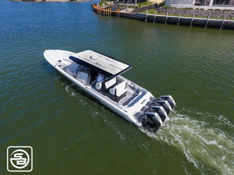 Slide: The Image of 2021 Nor-Tech 390 Sport boat cruising on a calm waterway. - 13