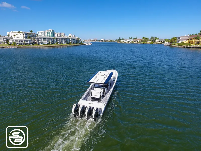 Slide: The Image of Nor-Tech 390 Sport 2021 boat cruising on a scenic waterway. - 14