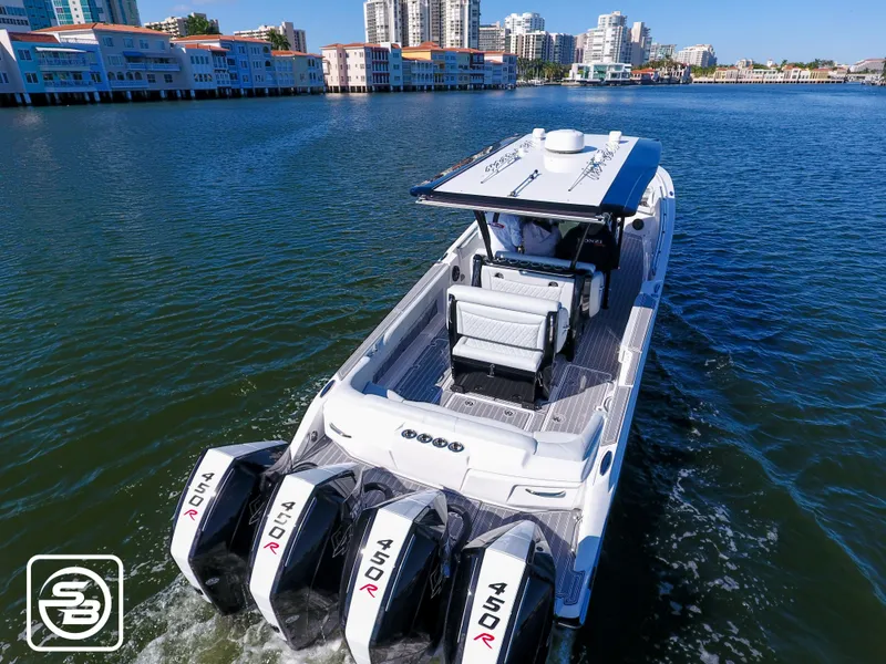 Slide: The Image of 2021 Nor-Tech 390 Sport boat cruising on a sunny waterfront with cityscape background. - 17