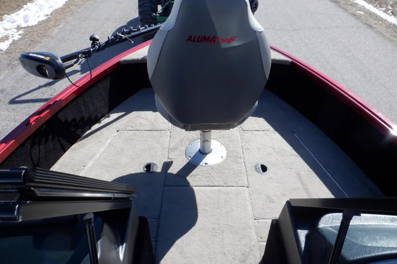 Slide: The Image of 2020 Alumacraft Competitor 165 Sport boat interior with seating and carpeted deck. - 19