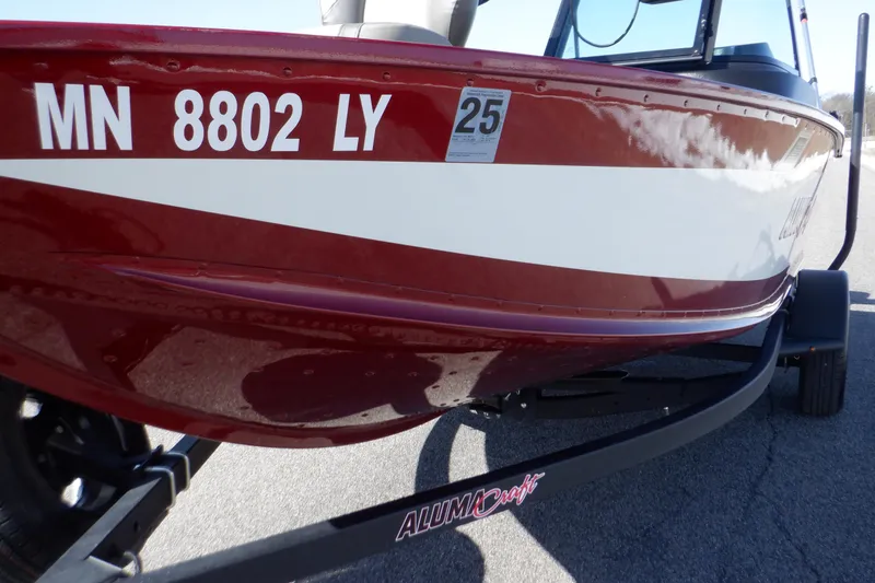 Slide: The Image of 2020 Alumacraft Competitor 165 Sport boat on trailer, red and white exterior, registration MN 8802 LY. - 34