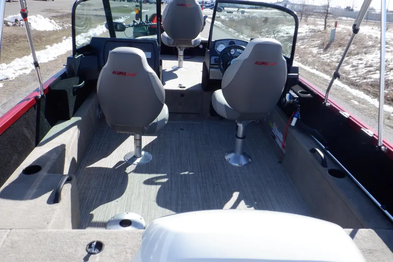 Slide: The Image of 2020 Alumacraft Competitor 165 Sport boat interior with seating and steering console. - 4