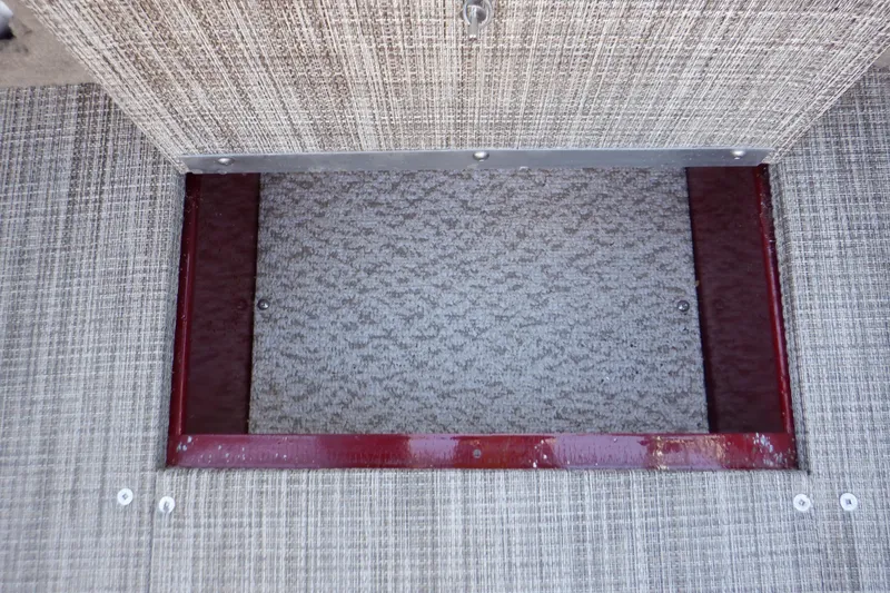 Slide: The Image of 2020 Alumacraft Competitor 165 Sport boat storage compartment with textured flooring. - 43