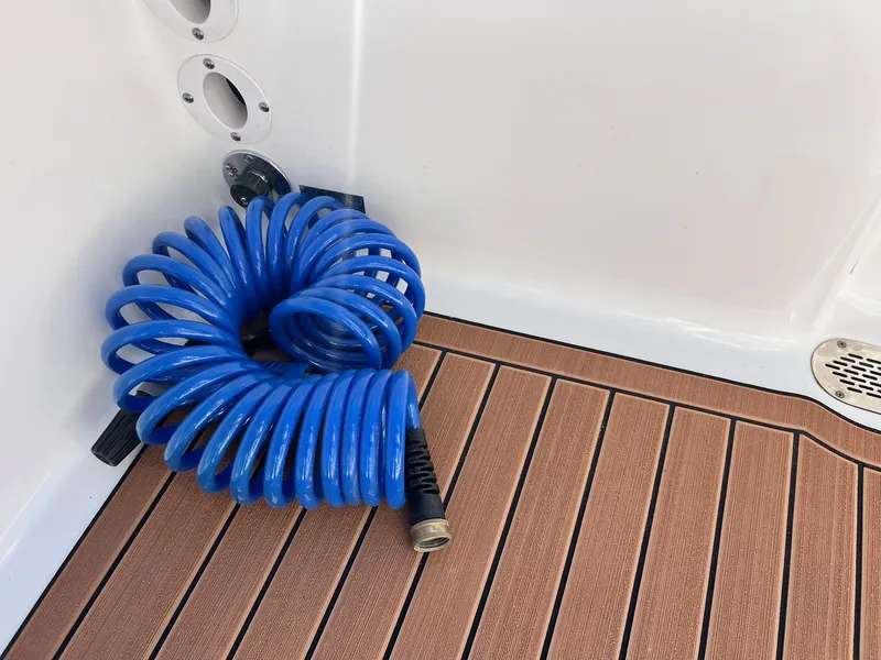 Slide: The Image of Blue coiled hose on 2024 Sea Pro 250 Bay boat deck. - 11