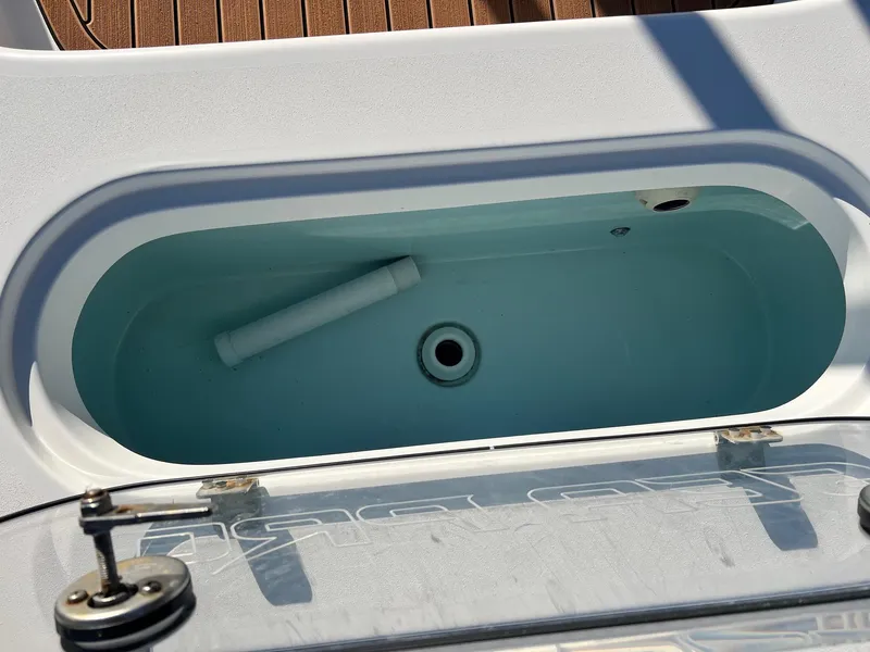 Slide: The Image of 2024 Sea Pro 250 Bay livewell with open lid, showcasing interior design. - 14