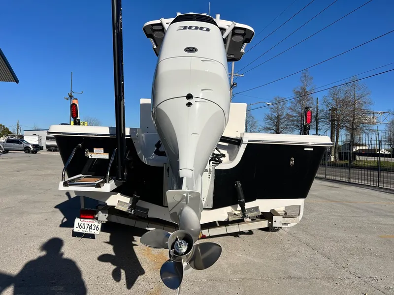 Slide: The Image of 2024 Sea Pro 250 Bay boat with powerful outboard motor, parked on a trailer. - 17