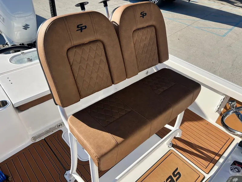 Slide: The Image of 2024 Sea Pro 250 Bay boat with brown cushioned seating and diamond stitching. - 20