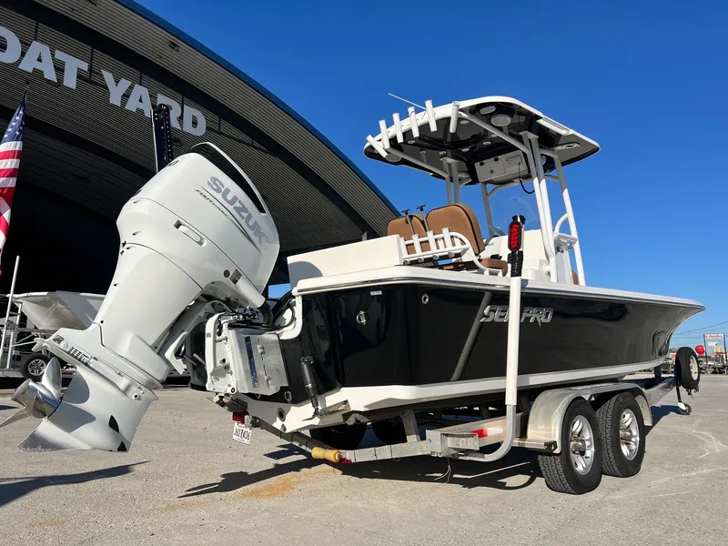 Slide: The Image of 2024 Sea Pro 250 Bay boat with Suzuki engine on trailer at boat yard. - 3