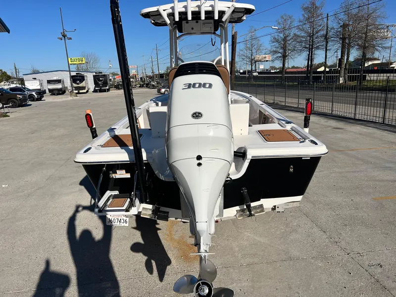 Slide: The Image of 2024 Sea Pro 250 Bay boat with powerful outboard motor, parked outdoors. - 5