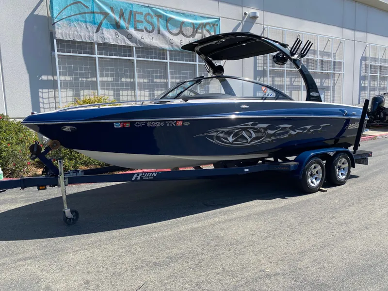 Slide: The Image of 2007 Malibu Wakesetter VLX boat on trailer, parked outside West Coast dealership. - 2