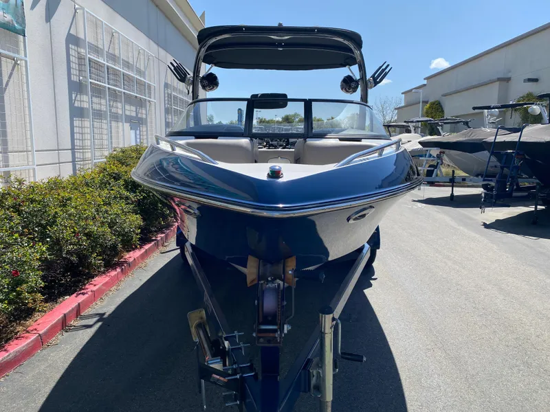 Slide: The Image of 2007 Malibu Wakesetter VLX boat on trailer, parked outdoors under clear sky. - 4