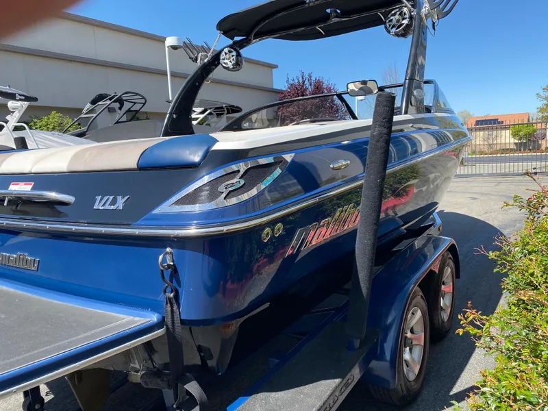 Slide: The Image of 2007 Malibu Wakesetter VLX boat on trailer, blue exterior, parked outdoors. - 6