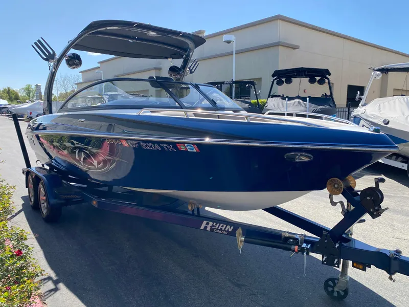 Slide: The Image of 2007 Malibu Wakesetter VLX boat on trailer, parked outdoors near a building. - 7