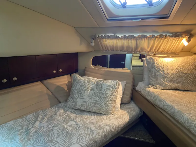 Slide: The Image of Cozy cabin interior of 2006 Sea Ray 40 Motor Yacht with plush bedding and natural light. - 19