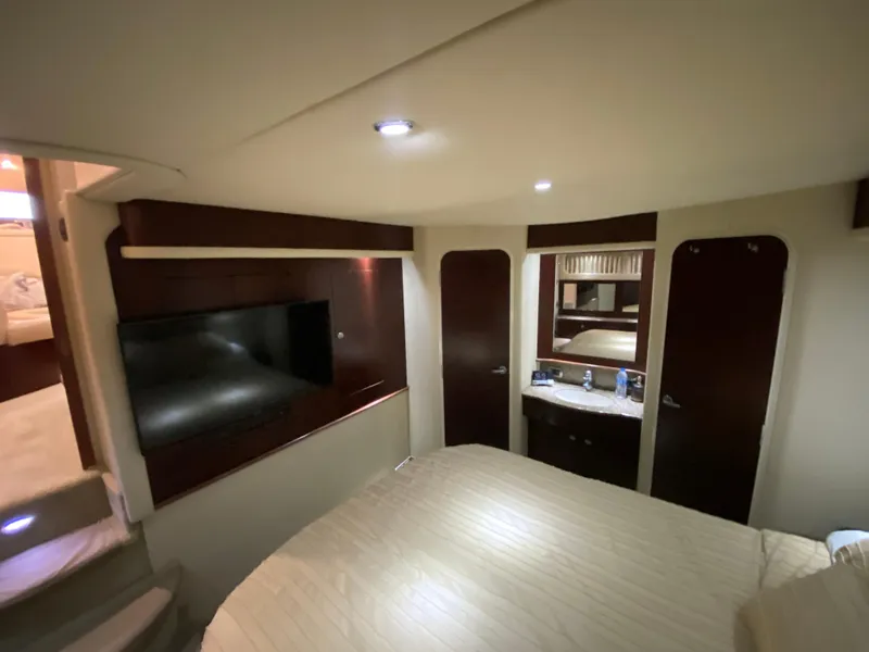 Slide: The Image of Luxurious interior of 2006 Sea Ray 40 Motor Yacht bedroom with TV and vanity. - 29
