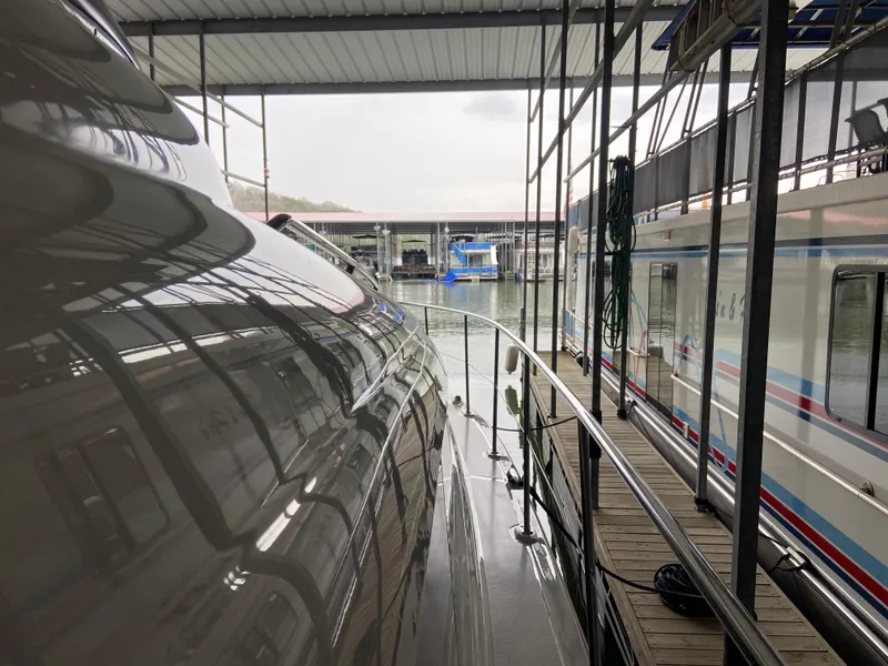 Slide: The Image of 2006 Sea Ray 40 Motor Yacht docked in a marina under a covered structure. - 35