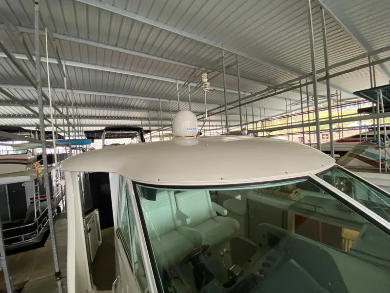 Slide: The Image of 2006 Sea Ray 40 Motor Yacht in covered marina, showcasing helm and seating area. - 37