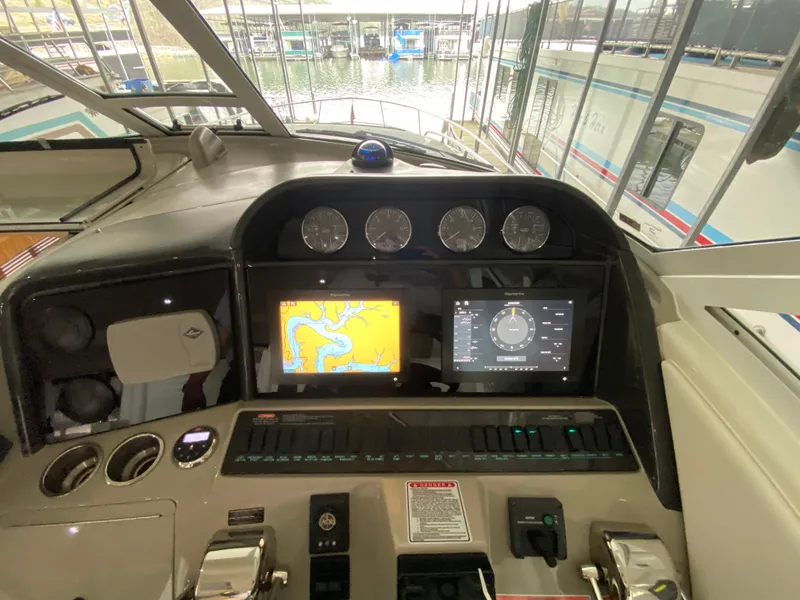 Slide: The Image of Control panel of a 2006 Sea Ray 40 Motor Yacht with navigation screens and gauges. - 9