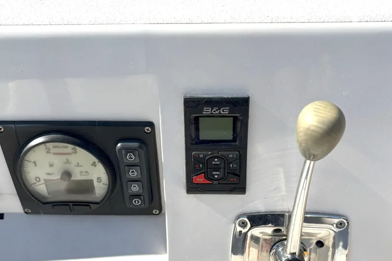 Slide: The Image of Control panel of a 2015 J Boats J 111, featuring gauges and a throttle lever. - 10