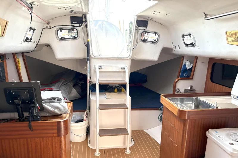 Slide: The Image of Interior of 2015 J Boats J 111 sailboat with wooden finishes and compact design. - 13
