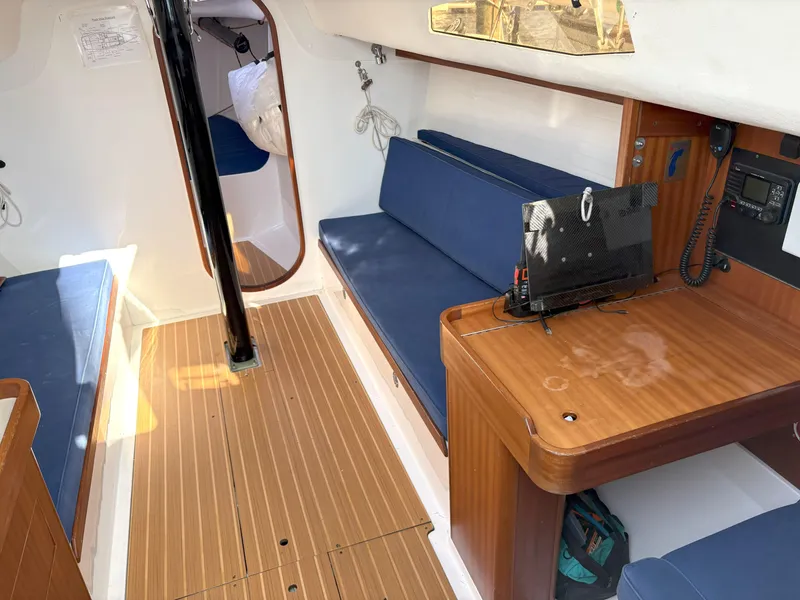 Slide: The Image of 2015 J Boats J 111 interior with blue seating and wooden flooring. - 14