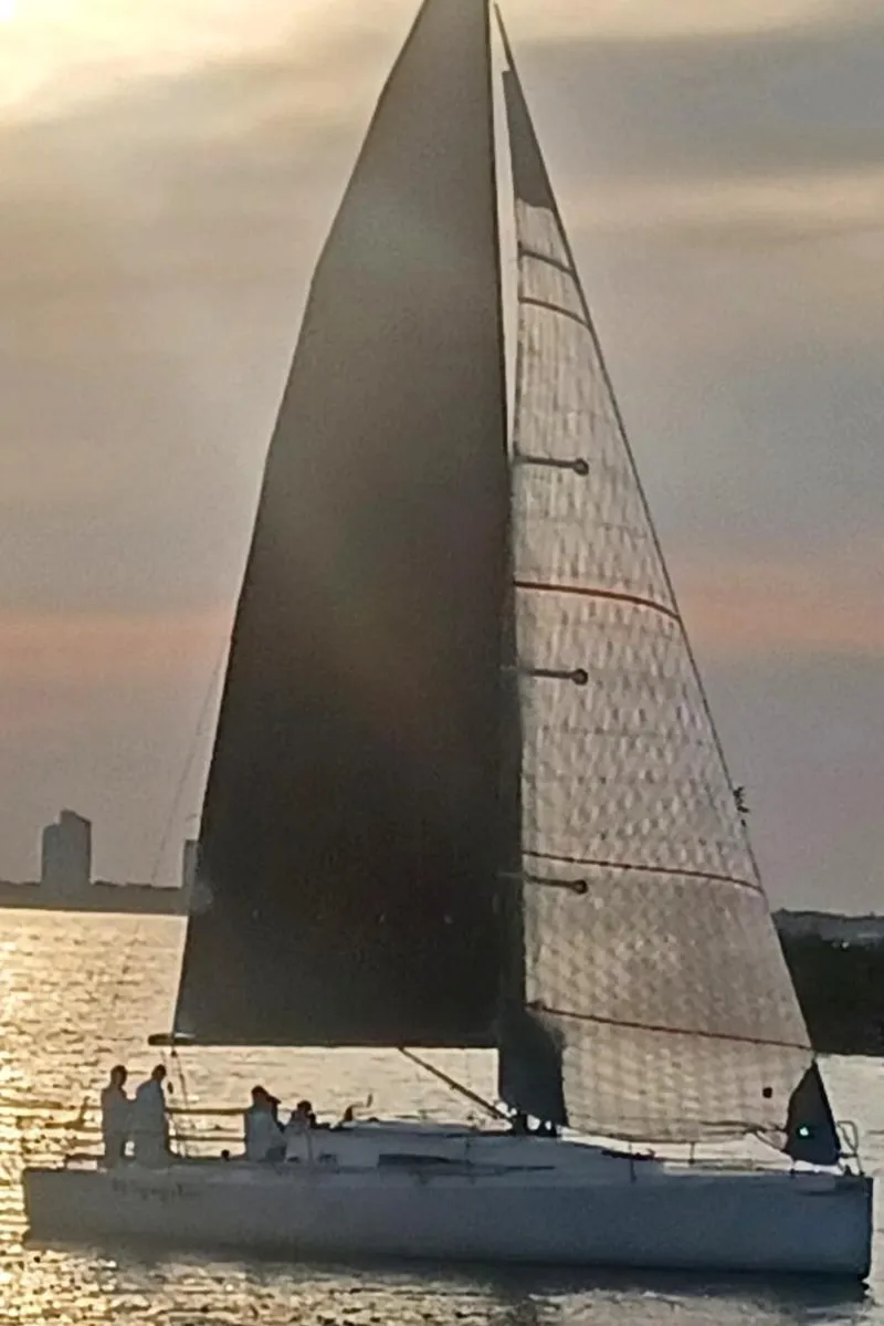 Slide: The Image of 2015 J Boats J 111 sailing at sunset with silhouetted crew. - 3