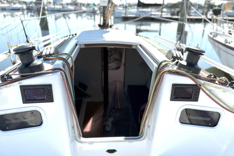 Slide: The Image of 2015 J Boats J 111 sailboat cockpit with open cabin, docked at marina. - 7