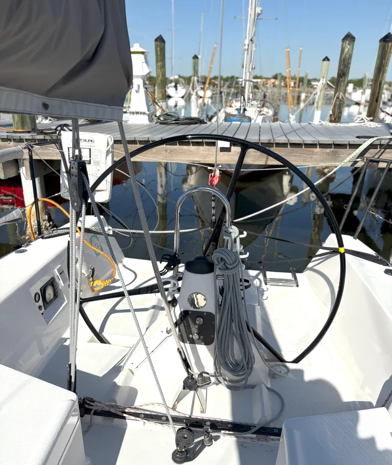 Slide: The Image of 2015 J Boats J 111 sailboat cockpit with steering wheel, docked at marina. - 9