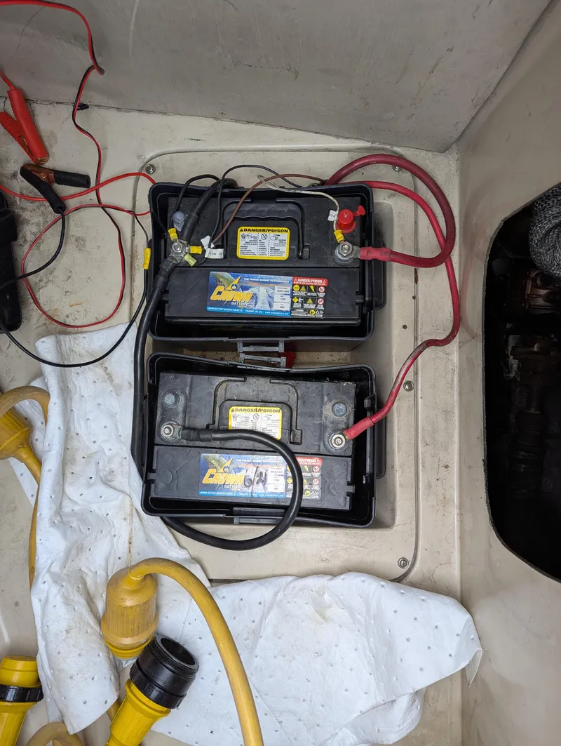 Slide: The Image of Two marine batteries in a Catalina 27 sailboat, 1983 model, with connected cables. - 18