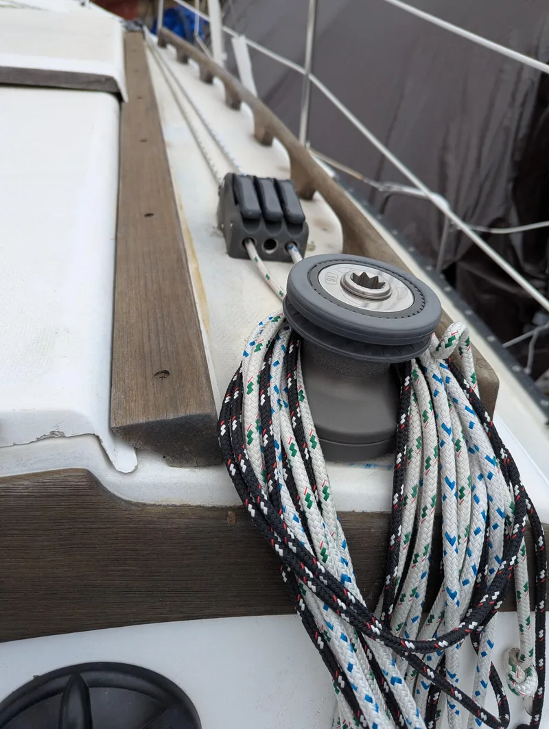 Slide: The Image of 1983 Catalina 27 sailboat deck with winch and ropes. - 4