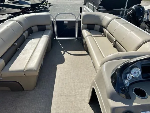 Slide: The Image of 2021 Sun Tracker Party Barge 20 DLX interior with beige seating and control panel. - 10