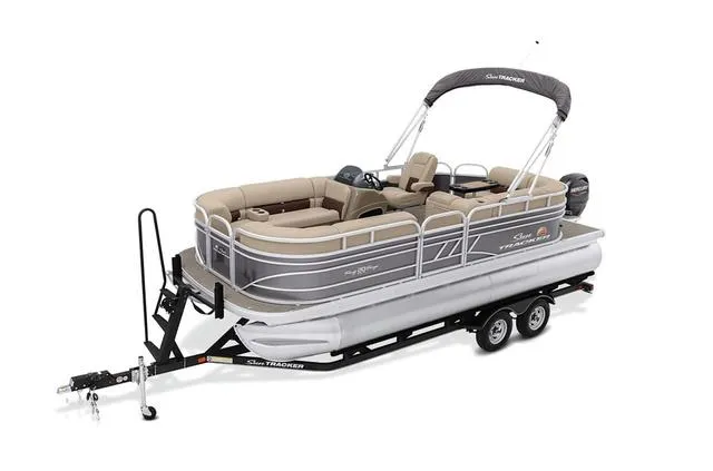 Slide: The Image of 2021 Sun Tracker Party Barge 20 DLX pontoon boat on trailer, featuring spacious seating and canopy. - 11