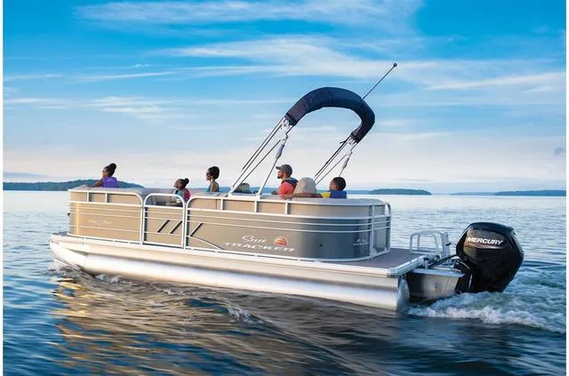 Slide: The Image of 2021 Sun Tracker Party Barge 20 DLX pontoon boat cruising on a serene lake. - 20