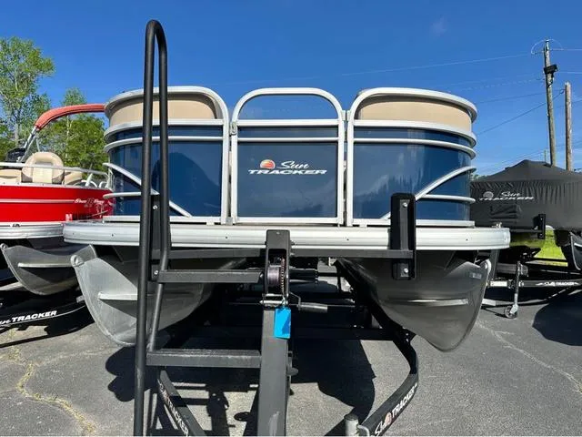 Slide: The Image of 2021 Sun Tracker Party Barge 20 DLX pontoon boat on trailer, blue and beige design. - 3