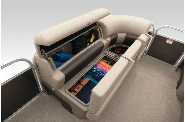 Slide: The Image of 2021 Sun Tracker Party Barge 20 DLX seating with storage compartments open, revealing colorful items. - 33