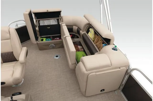 Slide: The Image of 2021 Sun Tracker Party Barge 20 DLX interior with open storage compartments and beige seating. - 39