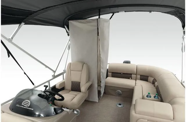 Slide: The Image of 2021 Sun Tracker Party Barge 20 DLX interior with seating and helm under canopy. - 45