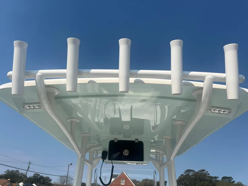 Slide: The Image of Pair Customs 24 Bay 2025 boat roof with rod holders against clear blue sky. - 10