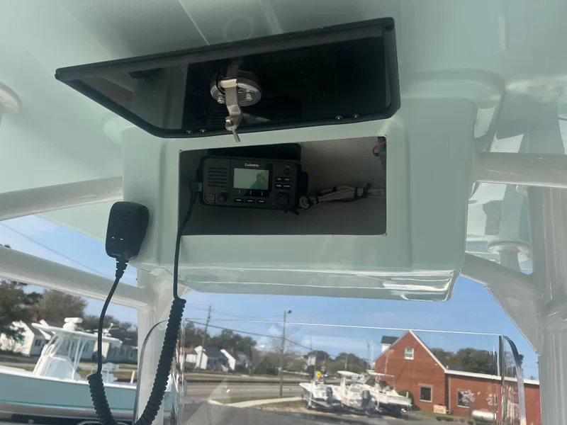 Slide: The Image of 2025 Pair Customs 24 Bay boat radio compartment with mounted communication device. - 12