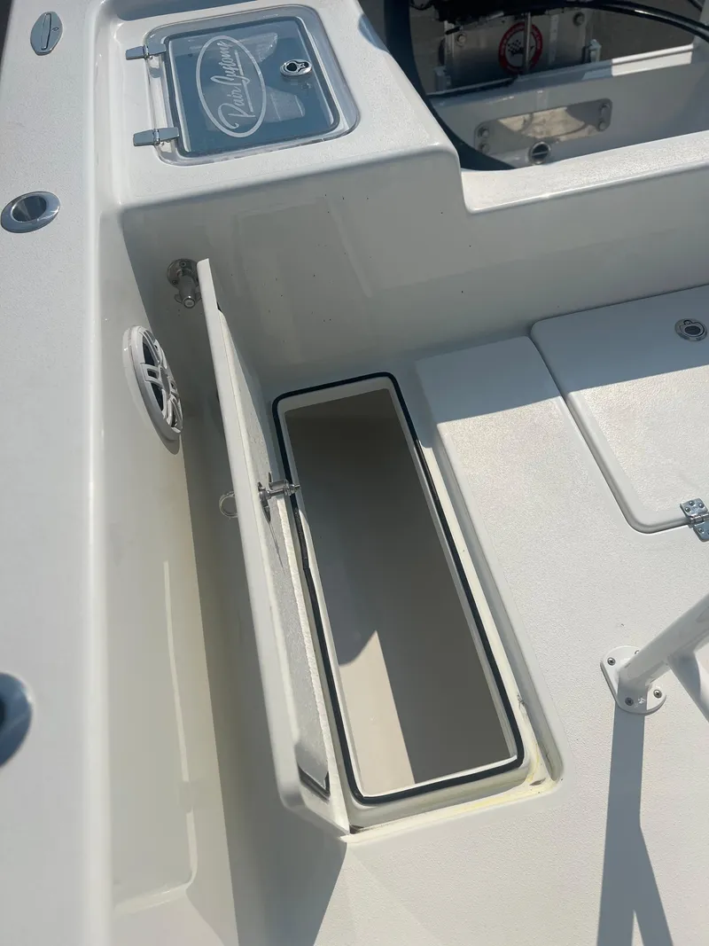 Slide: The Image of 2025 Pair Customs 24 Bay boat interior with open storage compartment. - 13