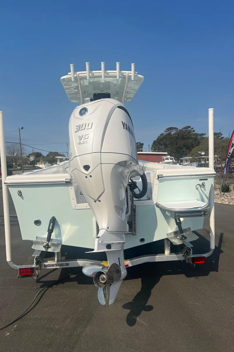 Slide: The Image of 2025 Pair Customs 24 Bay boat with Yamaha 300 V6 engine, rear view. - 15