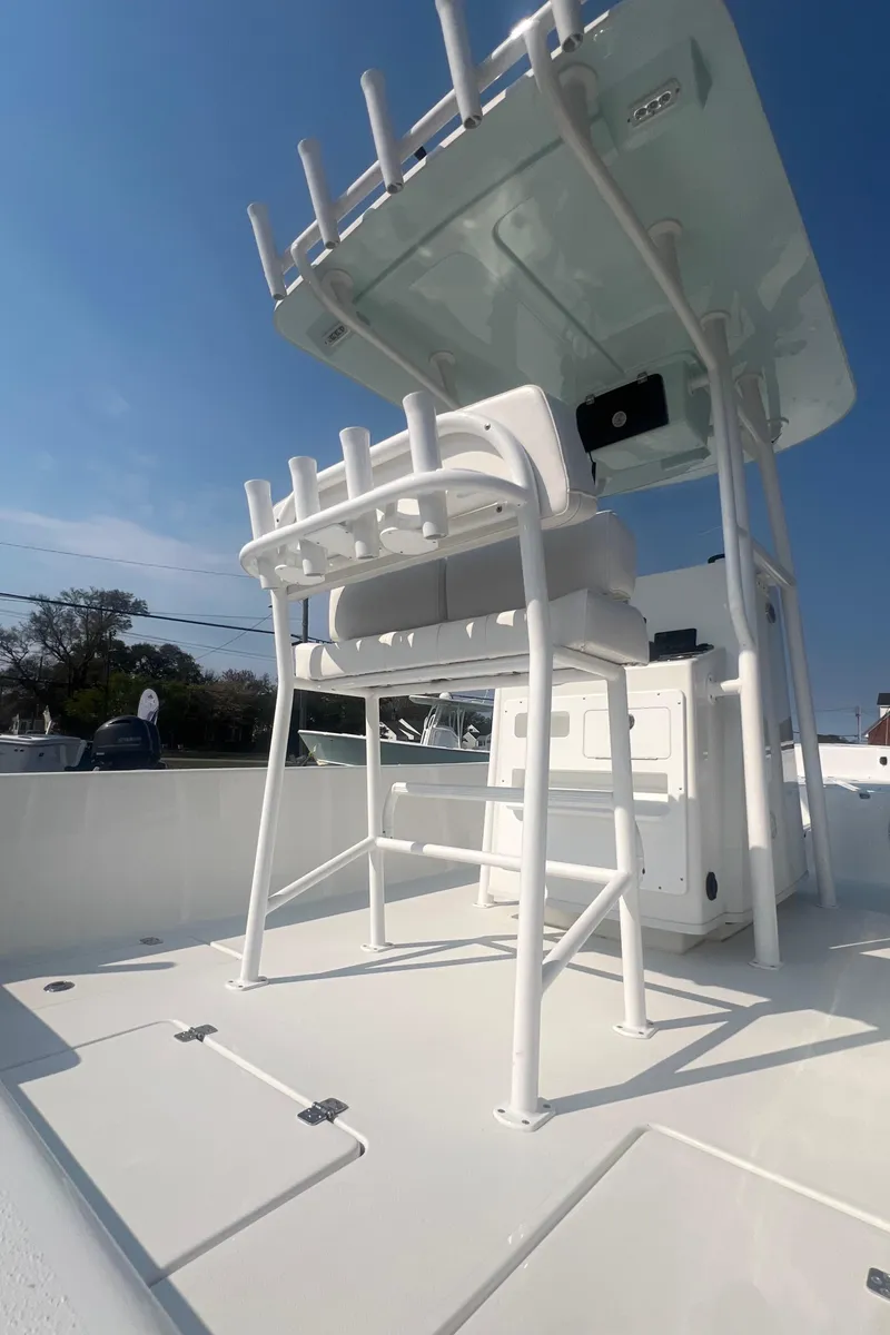 Slide: The Image of 2025 Pair Customs 24 Bay boat with sleek white design and modern features. - 19