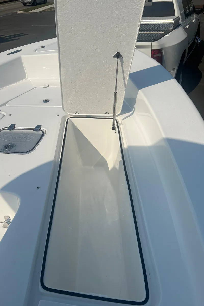 Slide: The Image of 2025 Pair Customs 24 Bay boat with open storage compartment on deck. - 27